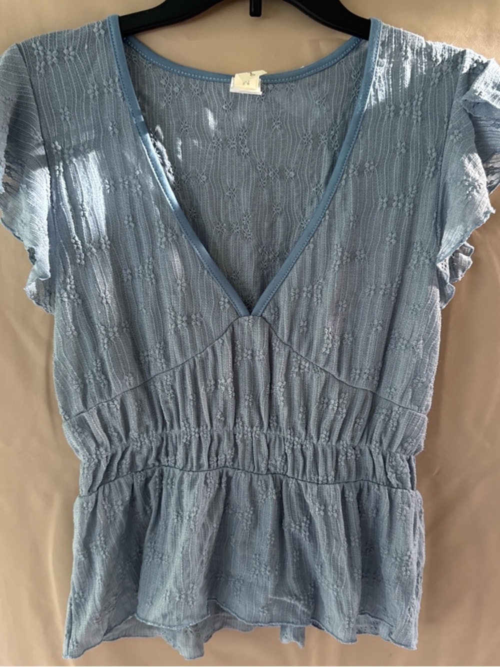 Light Blue Women’s V-Neck Top .